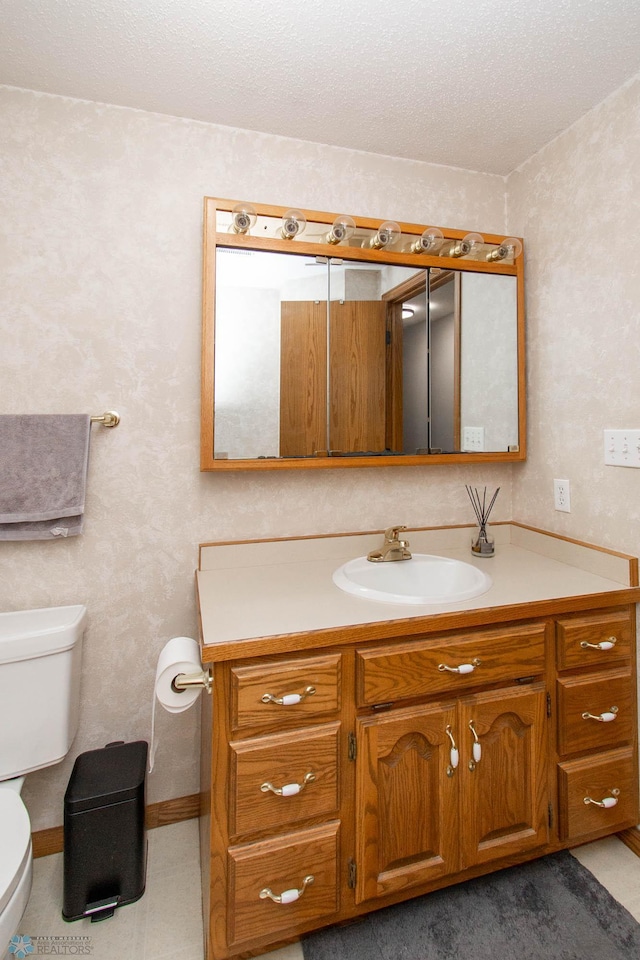 bathroom featuring toilet, vanity, and tile patterned floors