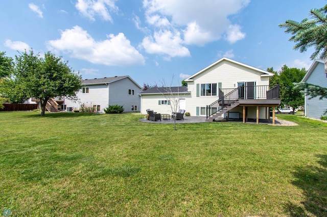 back of property with a wooden deck, a patio area, and a yard