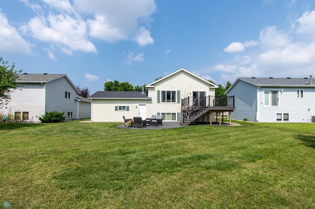 back of house featuring a yard, a patio area, and a deck