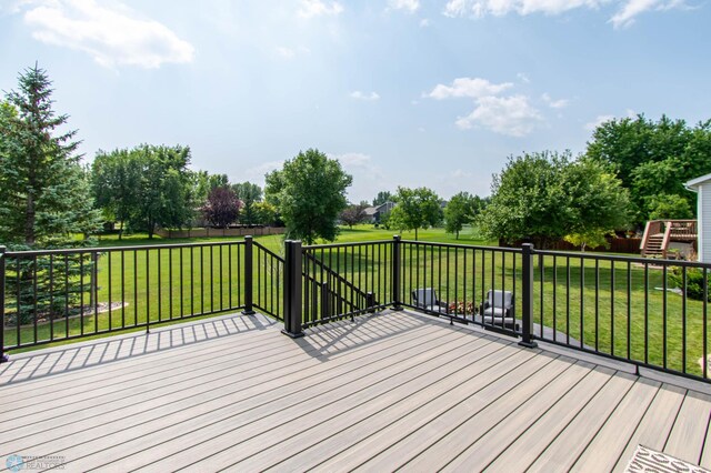 wooden deck featuring a yard