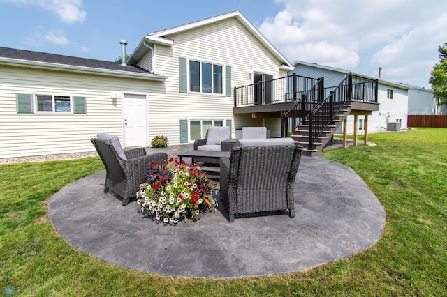 back of property with a wooden deck, a yard, central AC, and a patio