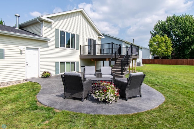 rear view of property with a patio, a deck, and a lawn