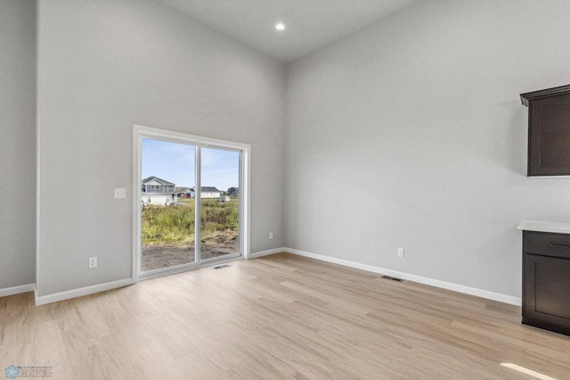 interior space featuring high vaulted ceiling and light hardwood / wood-style floors