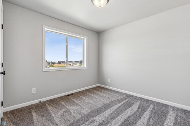 unfurnished room featuring carpet