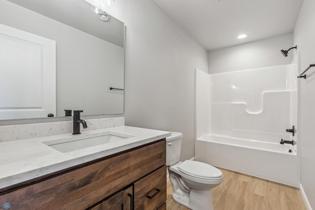 full bathroom featuring toilet, wood-type flooring, bathtub / shower combination, and vanity