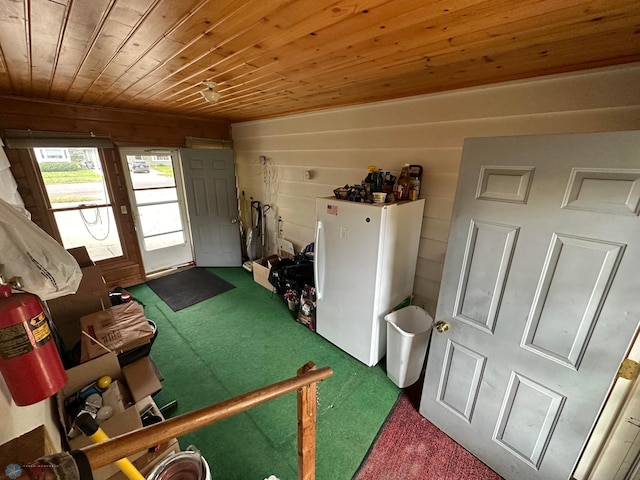 interior space featuring wooden ceiling, wood walls, and carpet floors