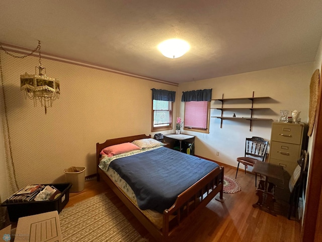 bedroom with hardwood / wood-style flooring