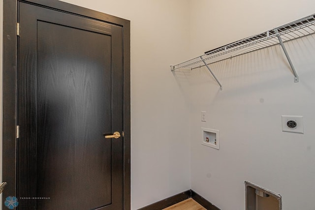 washroom featuring washer hookup, electric dryer hookup, and wood-type flooring