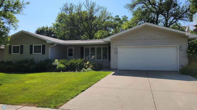 single story home with a front yard and a garage