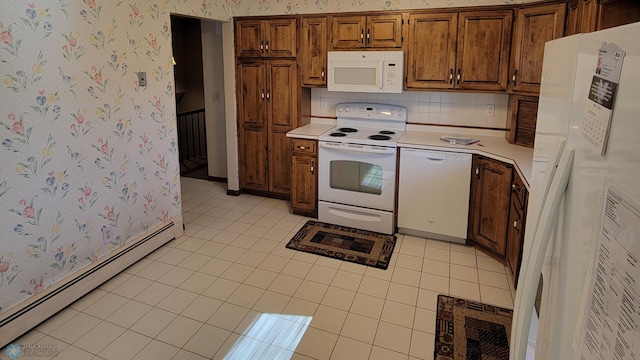 kitchen with backsplash, white appliances, light tile patterned flooring, and a baseboard heating unit