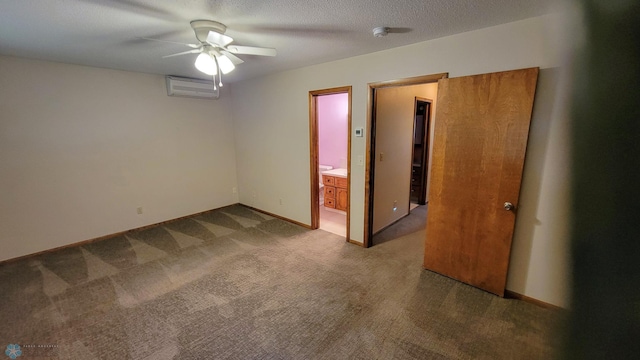 spare room with ceiling fan, carpet, a textured ceiling, and an AC wall unit