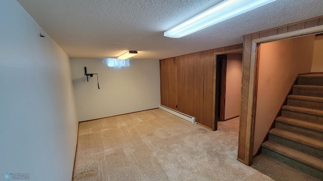 basement with light colored carpet, a textured ceiling, and a baseboard radiator