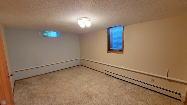 empty room with baseboard heating, light carpet, and a textured ceiling