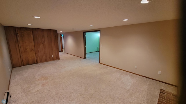 carpeted empty room with a textured ceiling