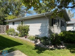 view of side of property with a lawn