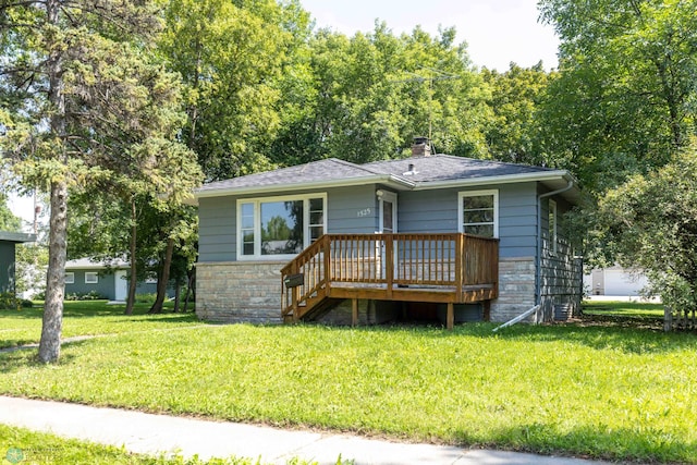 view of front facade with a front lawn, a deck, and cooling unit