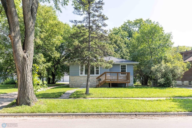 view of front of house with a wooden deck and a front yard