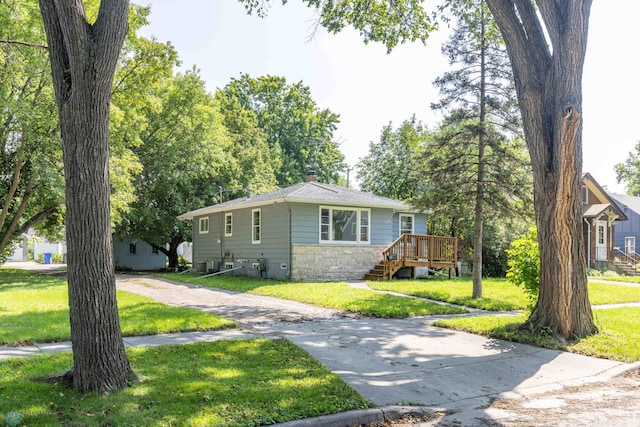 view of front of property featuring a front lawn and a deck