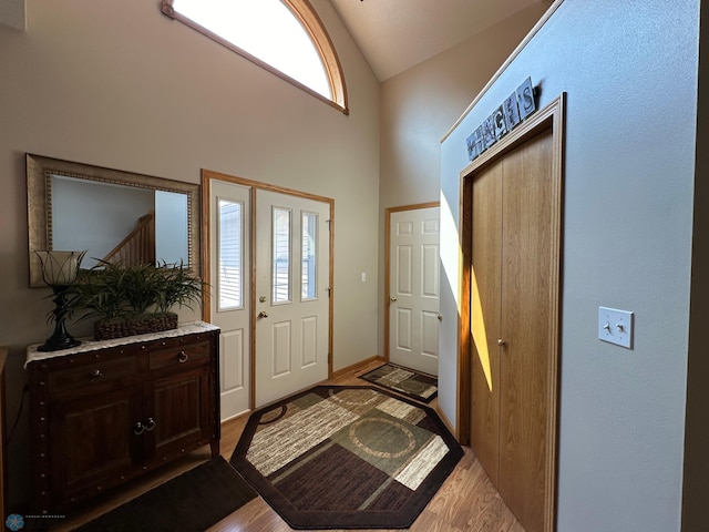 foyer entrance featuring vaulted ceiling and light hardwood / wood-style flooring