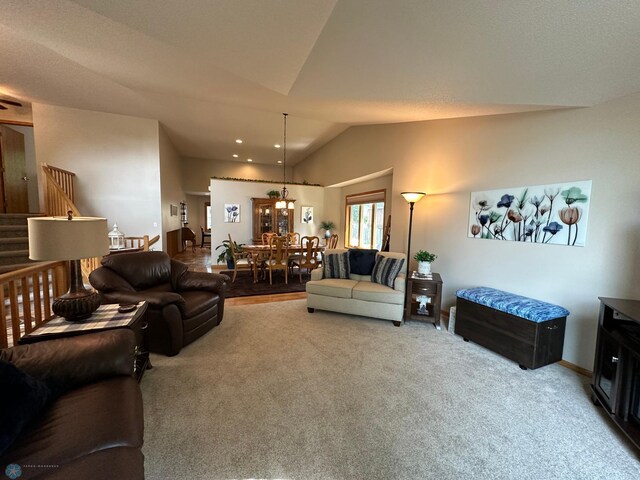 living room with carpet and vaulted ceiling