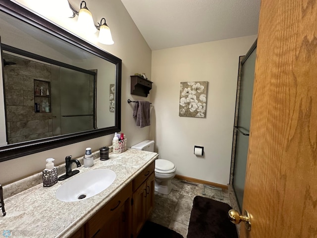 bathroom featuring vanity, toilet, an enclosed shower, and tile patterned flooring