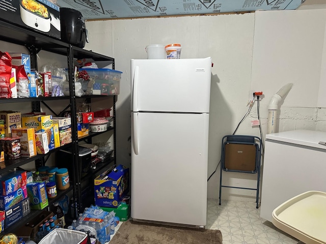 interior space with white refrigerator and light tile patterned flooring