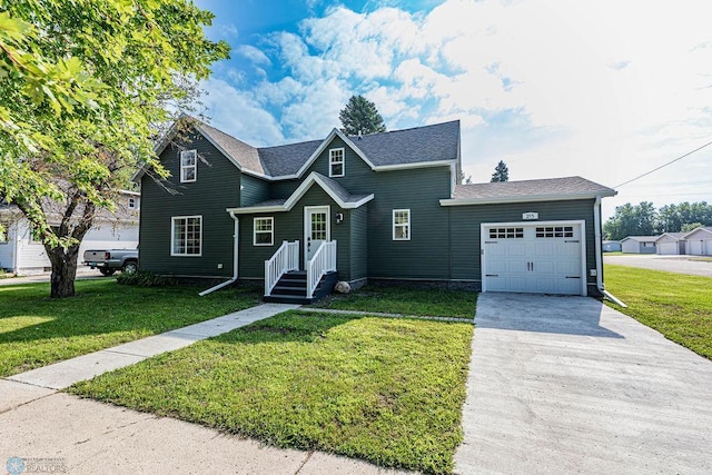 view of property featuring a garage and a front lawn