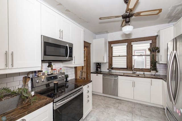 kitchen with backsplash, stainless steel appliances, and ceiling fan