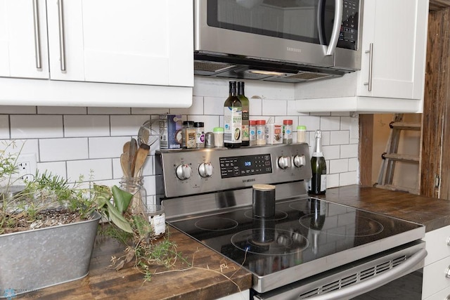 kitchen featuring white cabinetry, appliances with stainless steel finishes, and decorative backsplash