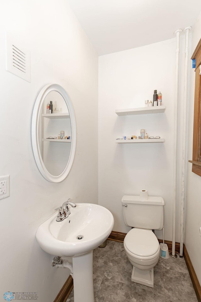 bathroom with tile patterned floors and toilet