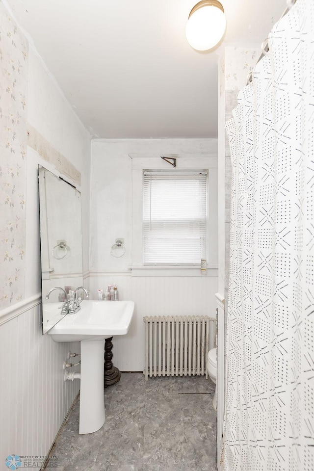 bathroom featuring radiator heating unit, toilet, tile patterned floors, sink, and curtained shower