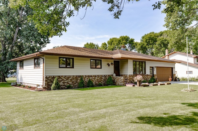 ranch-style home with a garage and a front lawn