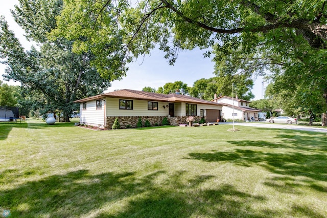 single story home featuring a garage and a front lawn