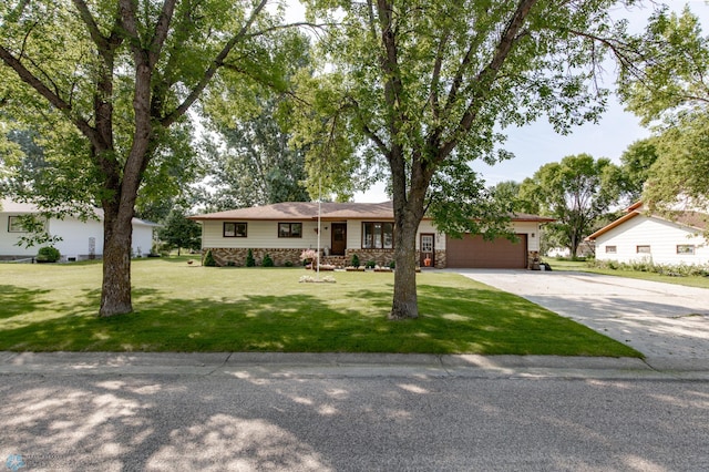 ranch-style house featuring a garage and a front yard