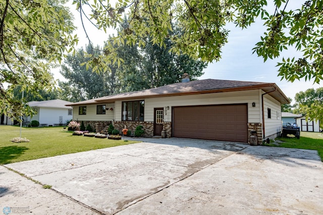 ranch-style home featuring a garage and a front lawn