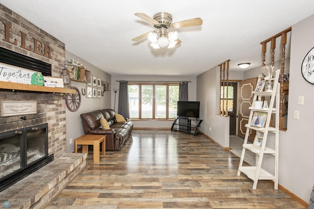 living room with a fireplace, ceiling fan, and hardwood / wood-style flooring