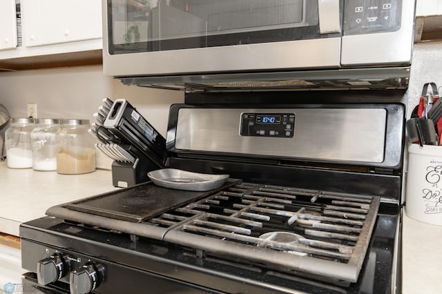 details featuring white cabinetry and range with gas cooktop