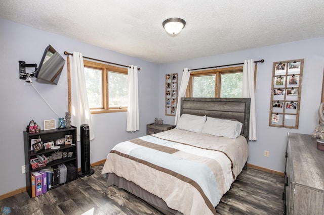 bedroom featuring a textured ceiling and dark hardwood / wood-style flooring