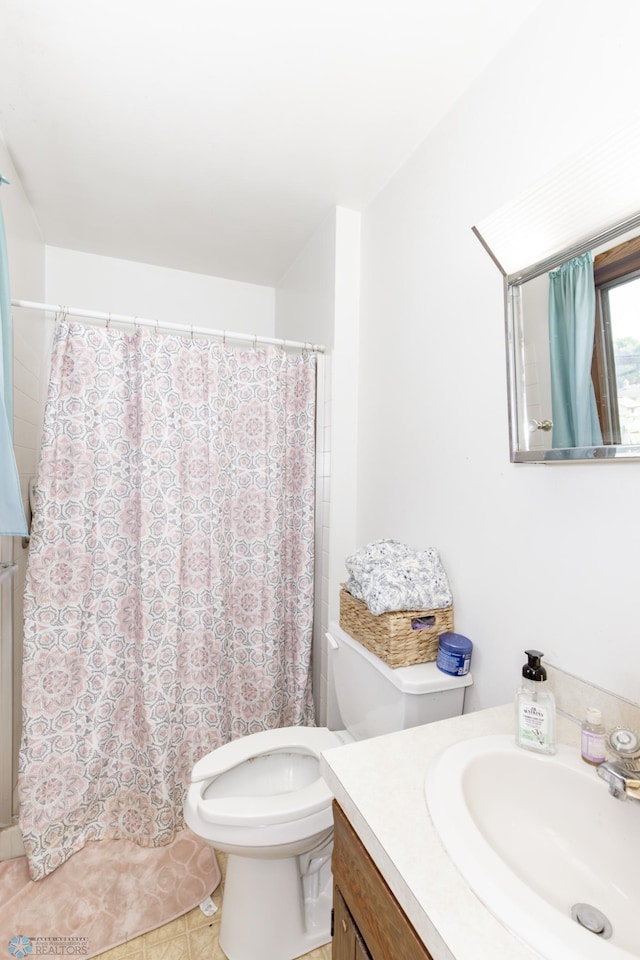 bathroom featuring tile patterned flooring, toilet, vanity, and a shower with curtain