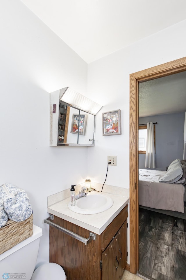 bathroom featuring vanity and toilet