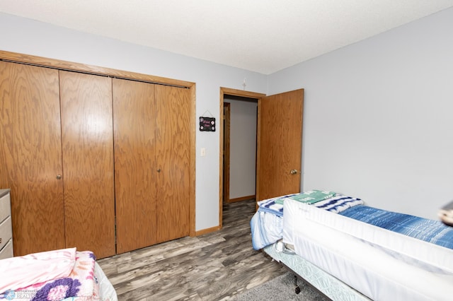 bedroom with a closet and light hardwood / wood-style floors