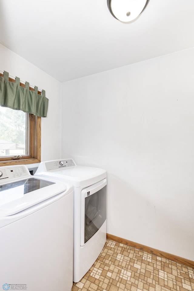 clothes washing area with light tile patterned floors and washing machine and clothes dryer