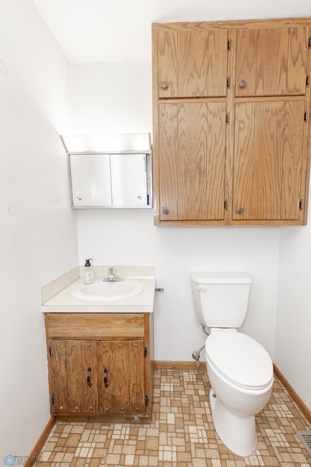 bathroom featuring tile patterned floors, vanity, and toilet