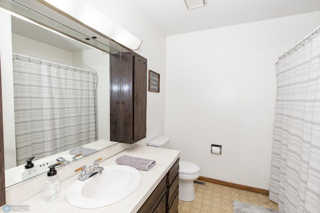 bathroom featuring toilet, vanity, and tile patterned floors