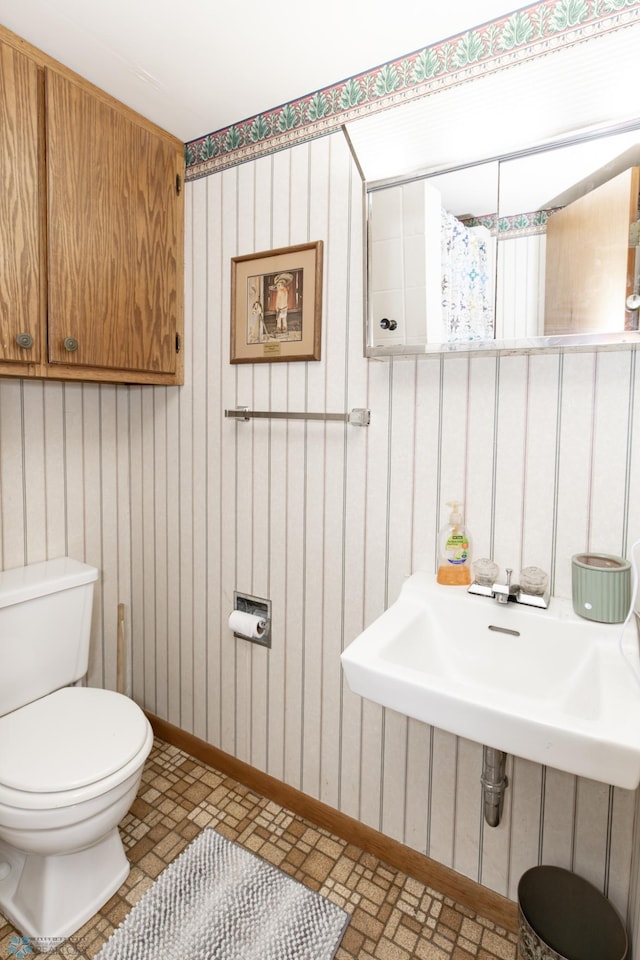 bathroom featuring toilet and tile patterned floors