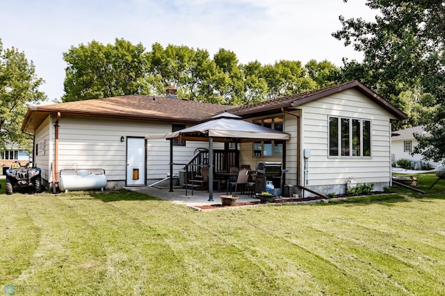 rear view of house featuring a patio and a yard