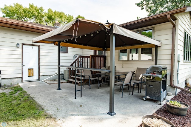 view of patio with grilling area and a gazebo