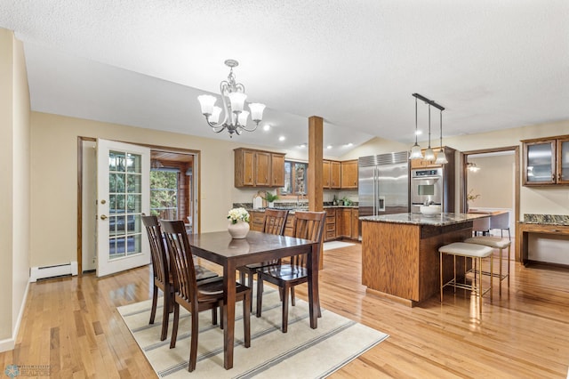 dining room featuring a baseboard radiator, a textured ceiling, a chandelier, vaulted ceiling, and light hardwood / wood-style floors