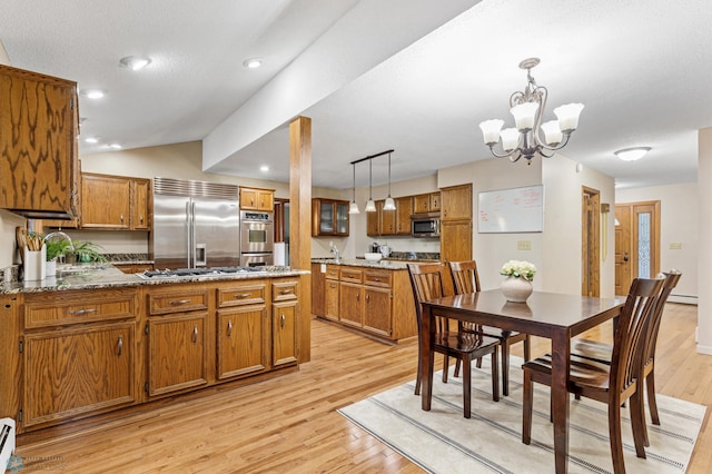 interior space with a textured ceiling, light hardwood / wood-style floors, lofted ceiling, baseboard heating, and an inviting chandelier