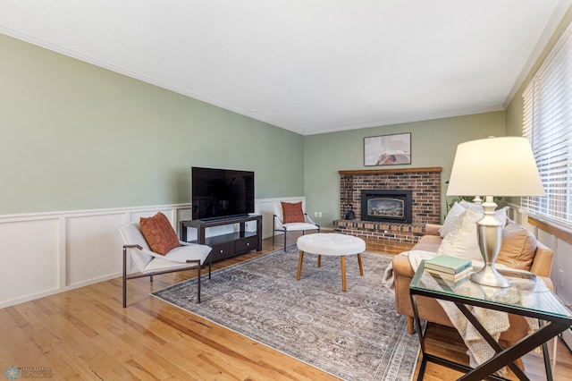 living room with ornamental molding and hardwood / wood-style floors